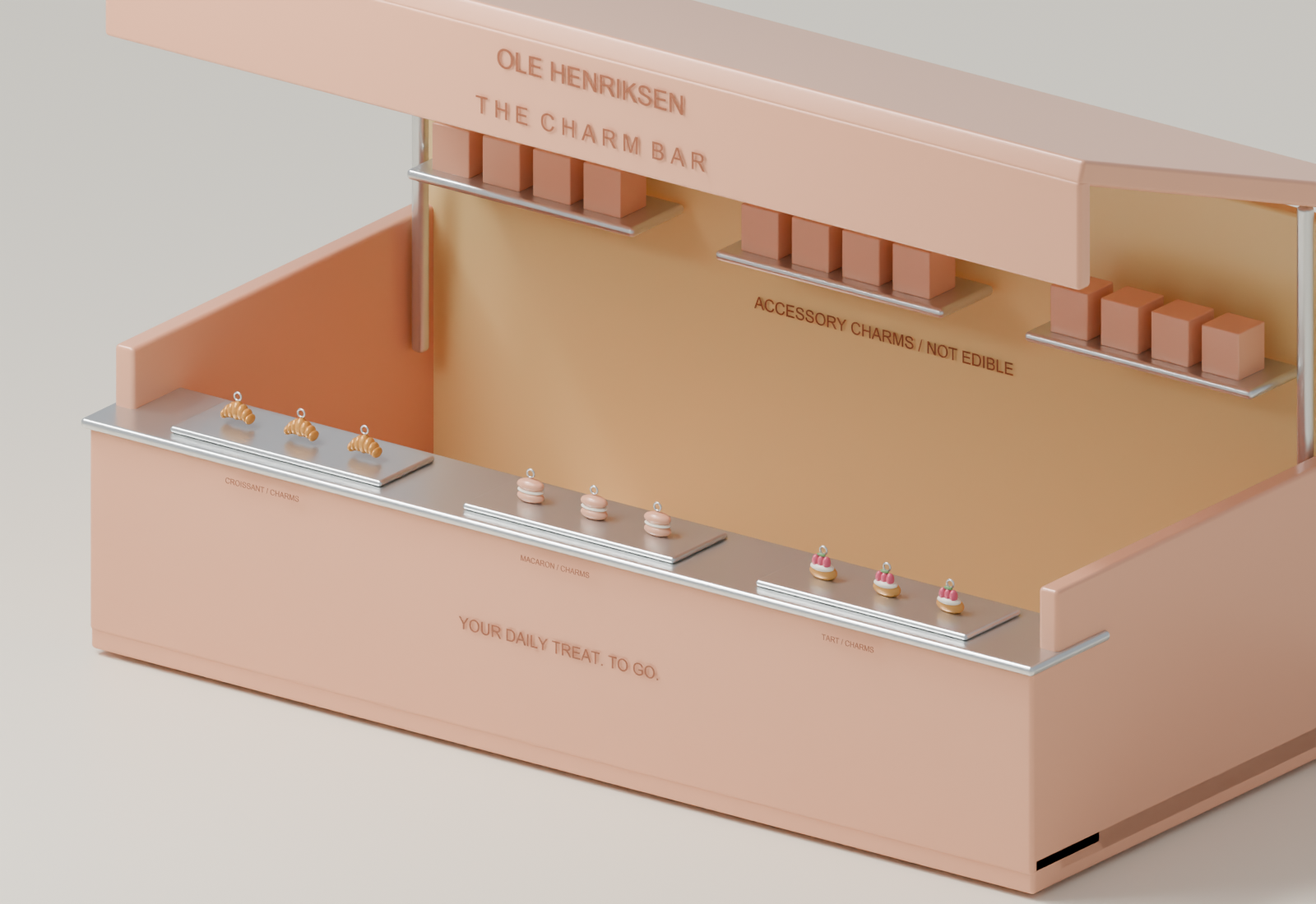 Close view of the steel counter with labeled miniature accessory charms and takeaway boxes.