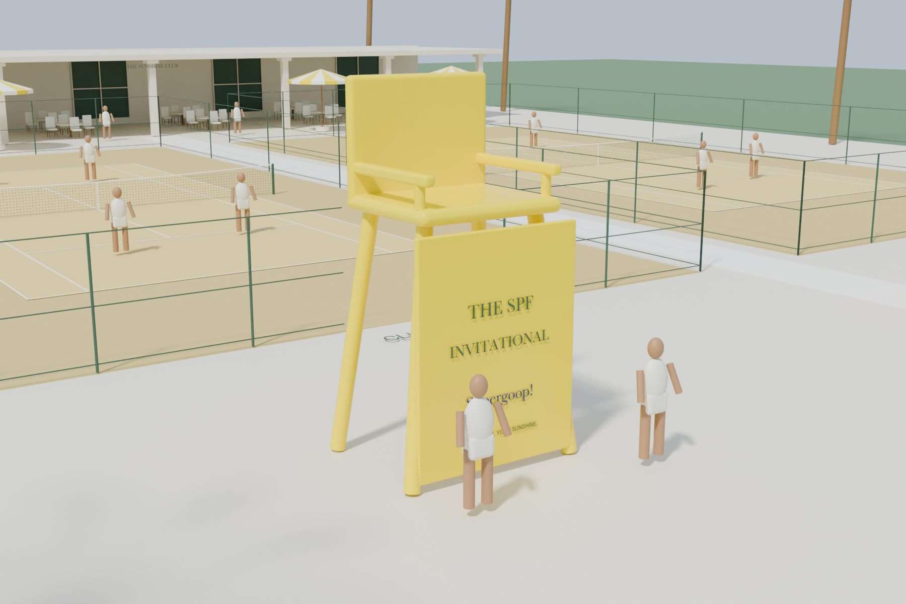 Oversized yellow umpire chair with a solid anti-climb front and people standing on the level terrace for portraits.