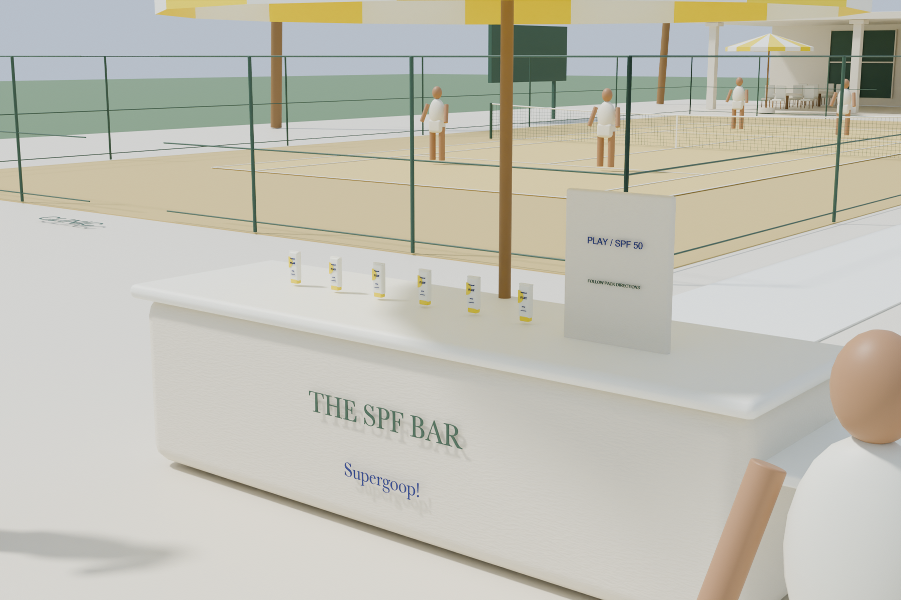 Shaded cream sampling counter with reconstructed white PLAY SPF 50 tubes and yellow caps.